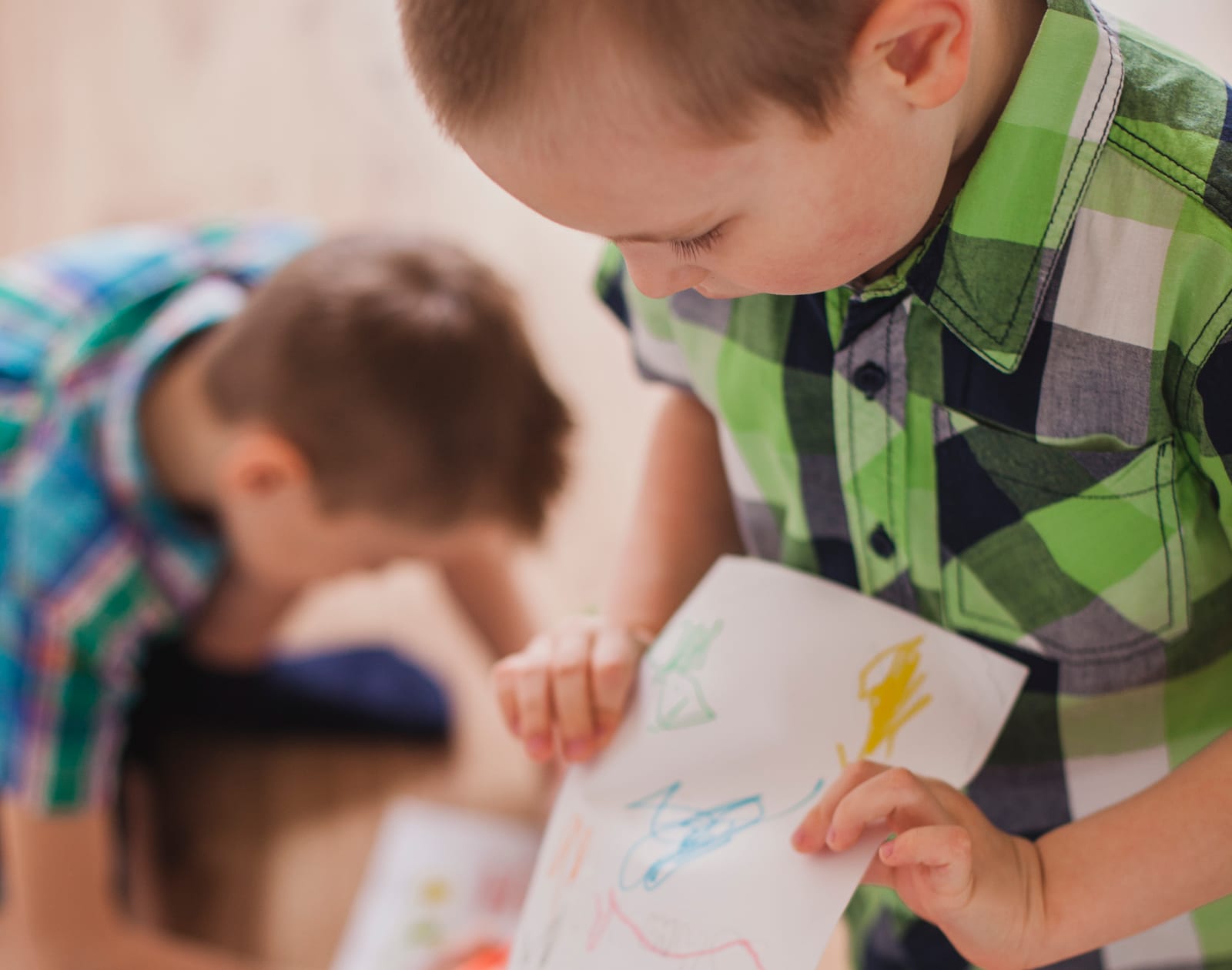 A child showing off a drawing they made