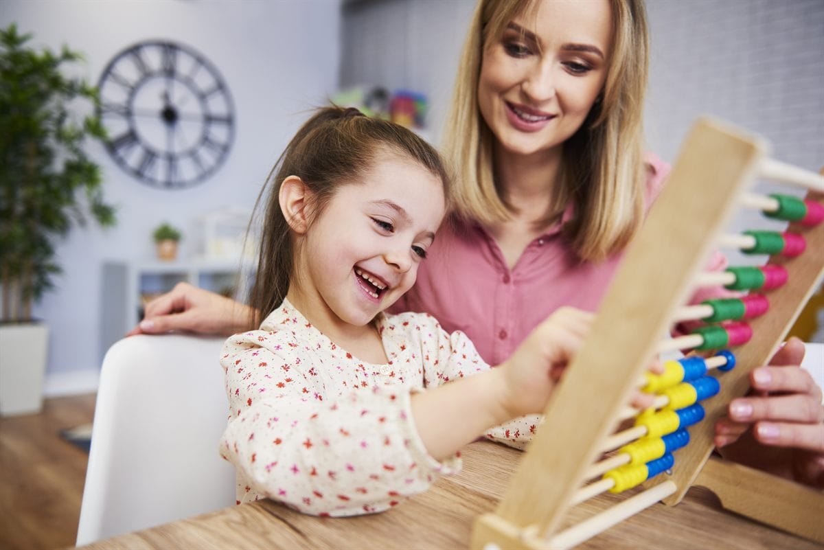A girl teacher using an abacus for homeschooling