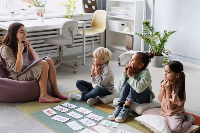 A therapist and children smiling during a session